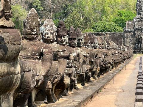       Ancient statues of warriors in a row.
  