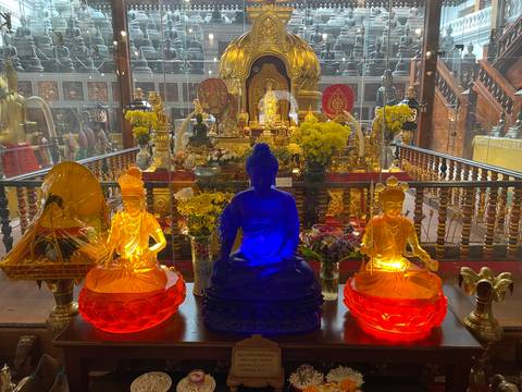 Colorful shrine with golden Buddha statues.