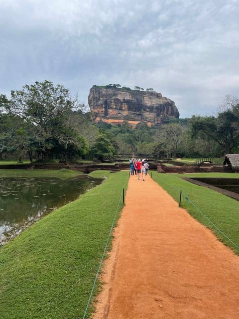       Visitors walking towards Sigiriya rock fortress.
  