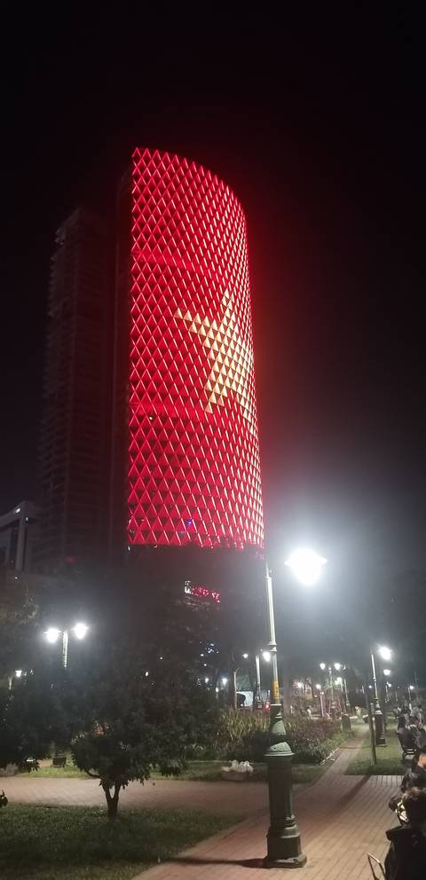 Illuminated building with star decoration at night.