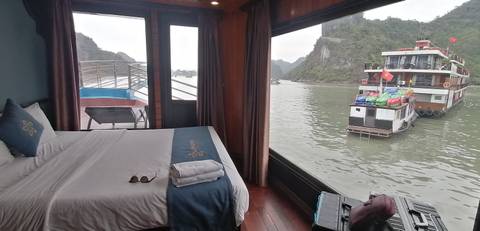 View from a cruise cabin with boats visible through the window.