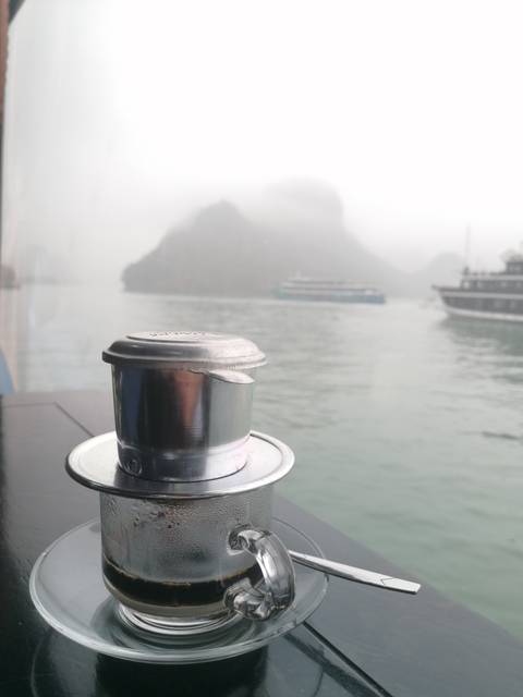 Vietnamese coffee filter with a view of the bay.