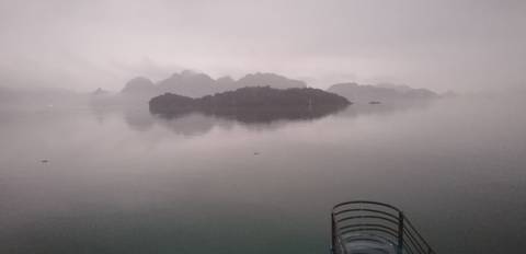 Foggy view of islands in Halong Bay.