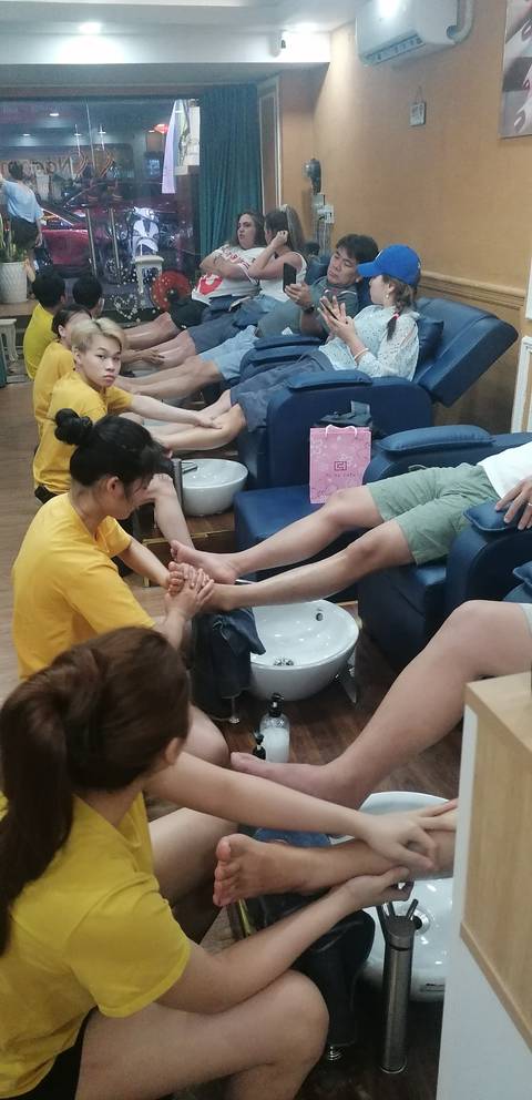       Indoor foot massage setup with customers.
  