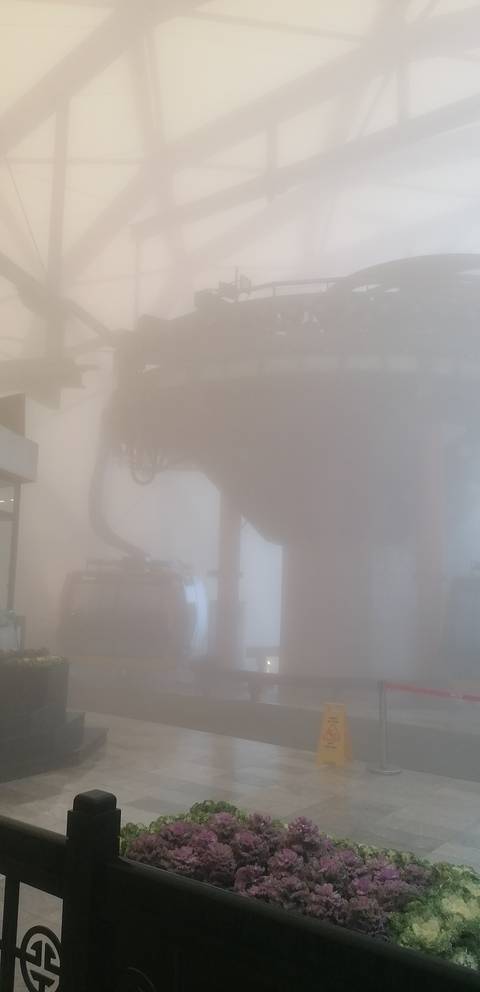      Heavily foggy scene with cable car barely visible.
  