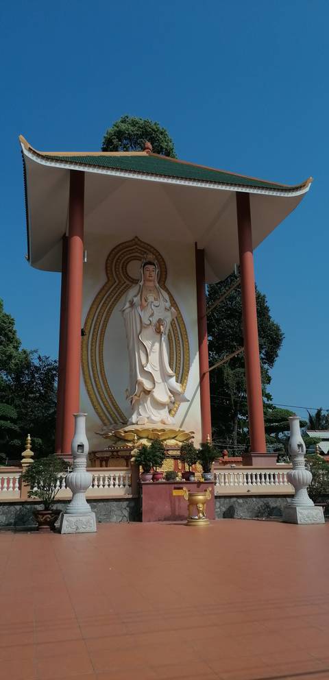 Tall statue against a blue sky.
