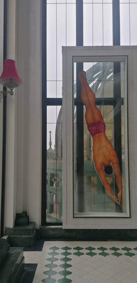 Stained glass window with a diver figure.