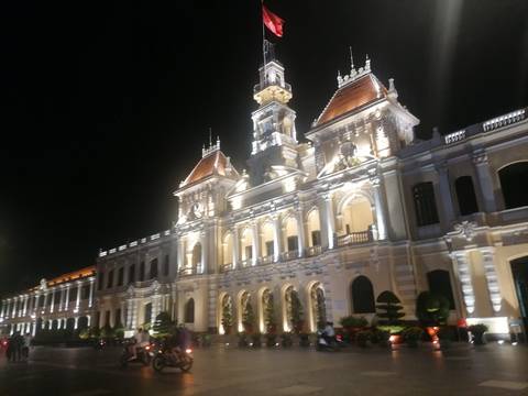 Illuminated, ornate building at night.