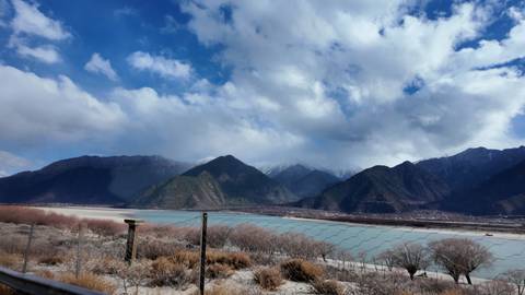 Scenic mountain view with a river in the foreground.