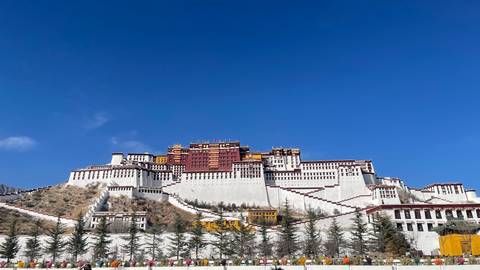 Potala Palace under a clear blue sky.