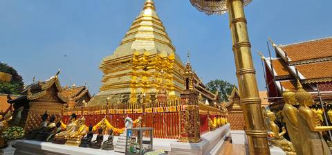 A golden temple with intricate details and multiple statues.