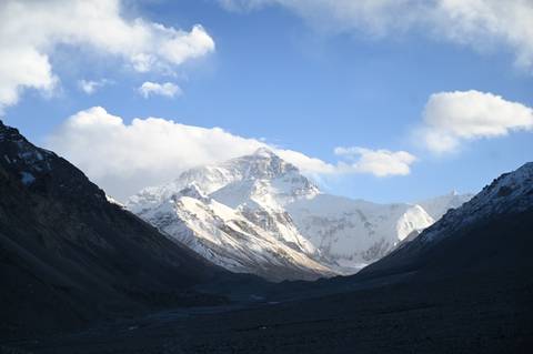 Majestic view of Mount Everest, snow-covered under a blue sky.