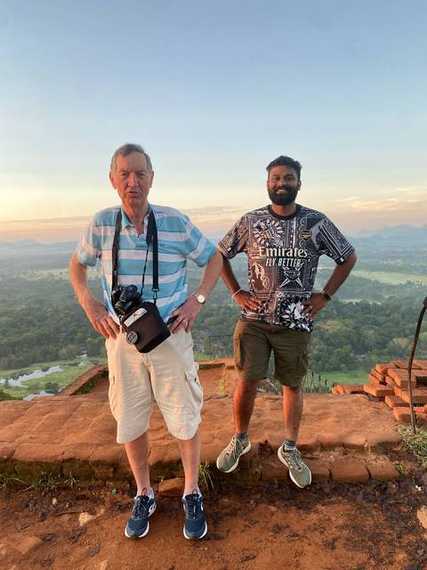 Two people posing on a scenic viewpoint.
