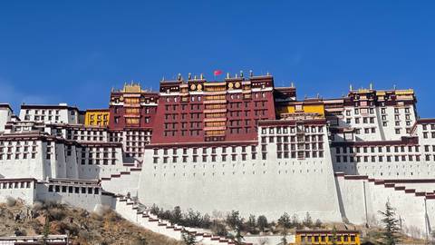 The Potala Palace, a multi-story building with red and white colors.