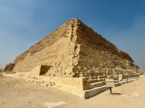       The Step Pyramid of Djoser in a desert setting.
  