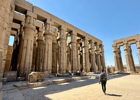       Large stone columns in an ancient temple complex.
  