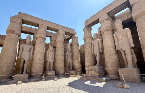       Ancient statues and columns at a temple site.
  