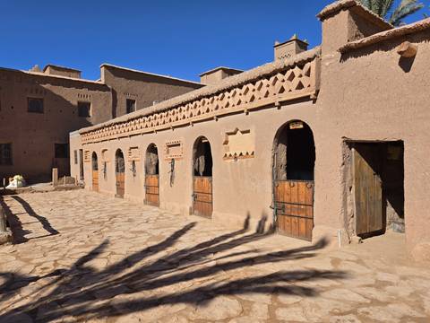       An architectural building with carved wood doors.
  