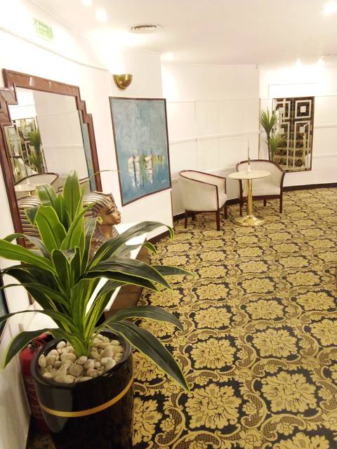 An interior of a waiting area with Egyptian-themed decor.