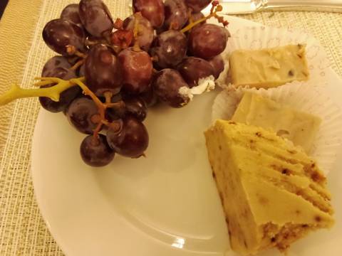 Plate with grapes and dessert slices.