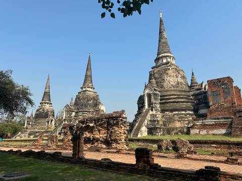       Ancient temple ruins with spires under a clear blue sky.
  