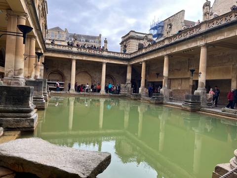       Tourists viewing the Roman Baths in Bath.
  