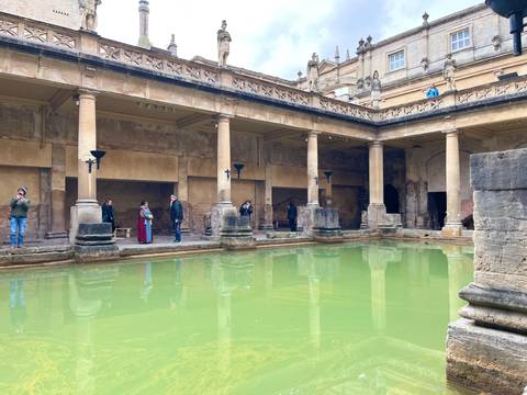       Tourists visiting the historic Roman Baths in Bath, England.
  