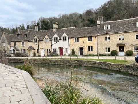       Traditional stone cottages along a small river.
  