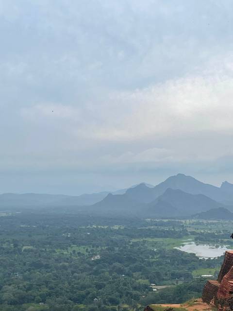 Misty mountain range under a cloudy sky.