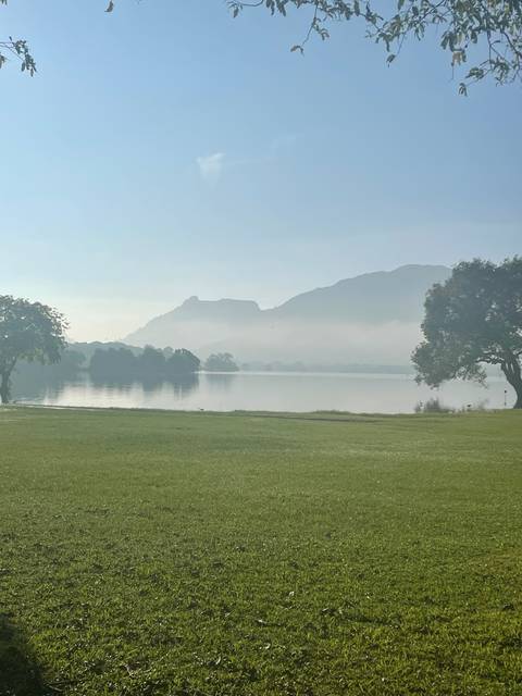       A calm lake with mountains in the background.
  
