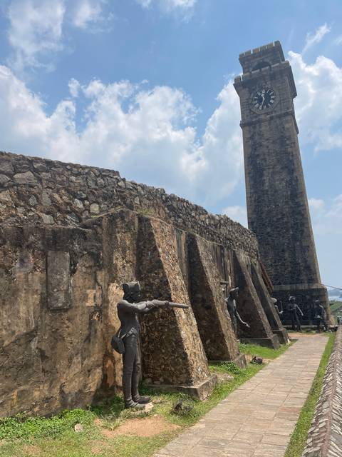       Historical fort with statues of soldiers.
  