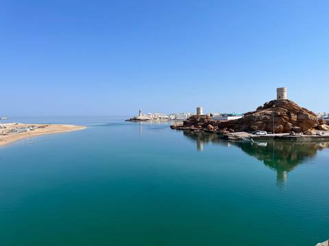 Relaxing view of coastline with water reflections.