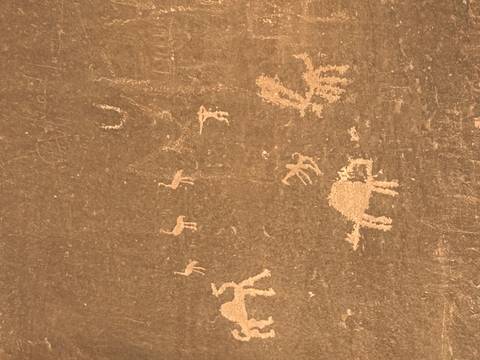       Close-up of ancient petroglyphs on rock surface.
  