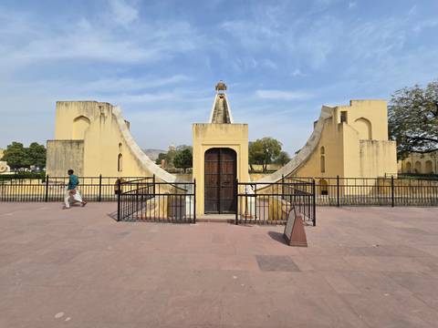       Astrological instrument in an open area with visitors.
  