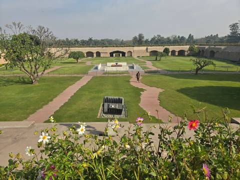       Large garden area with walkways and a monument.
  