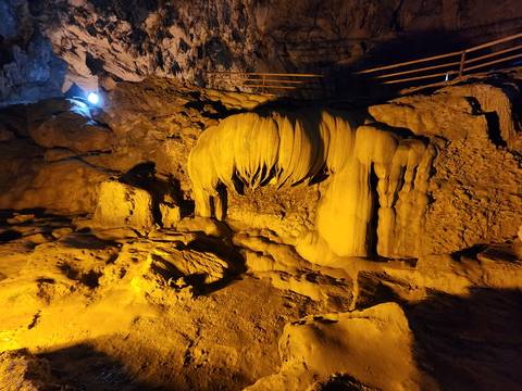       Unique rock formations in a cave with lighting.
  