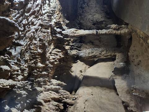       Stalactites and stalagmites forming in a cave.
  