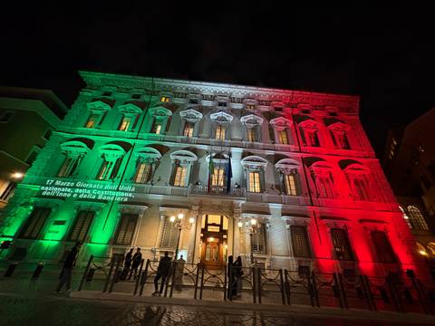       A beautifully lit building in Italian national colors at night.
  