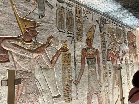 Ancient Egyptian reliefs and carvings on a wall.