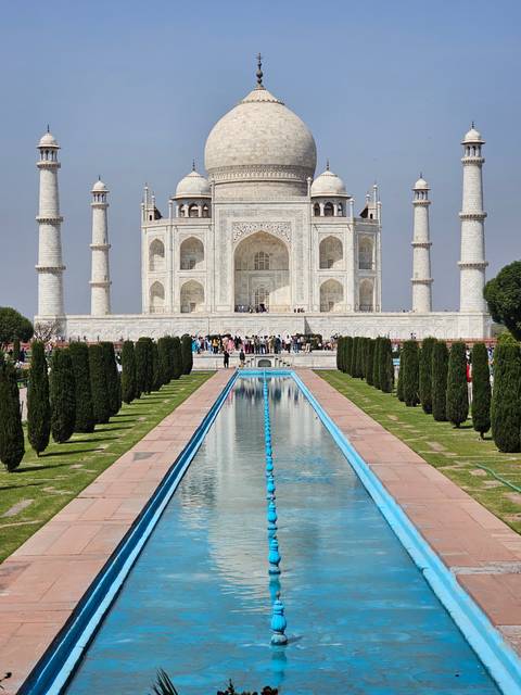       Taj Mahal with ornamental gardens in the foreground.
  