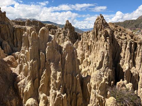 Eroded rock formations in a valley landscape.