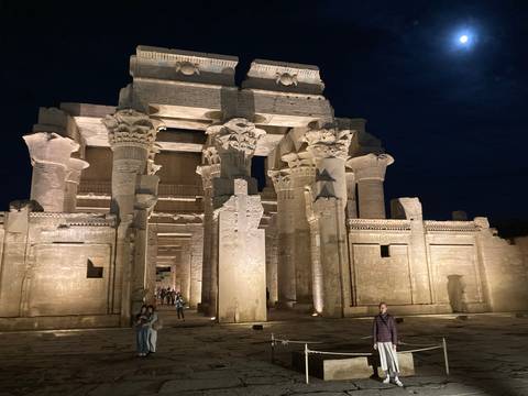       An illuminated ancient temple against a night sky.
  