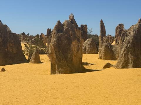 Rock formations in a desert-like environment under a clear sky.
