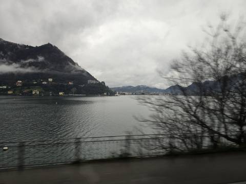 Rainy lake view with cloudy mountains.