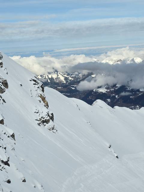       Snowy mountain peaks under cloudy skies.
  