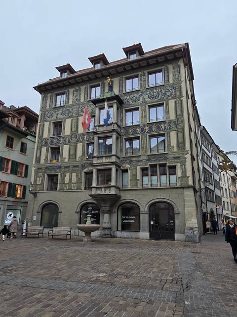 Building with detailed facade art and flags.