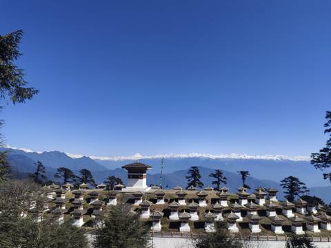 Mountain range with a series of chortens in the foreground.