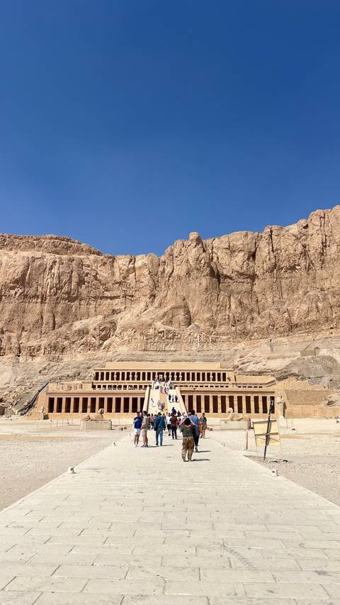 Terraced temple complex with tourists.