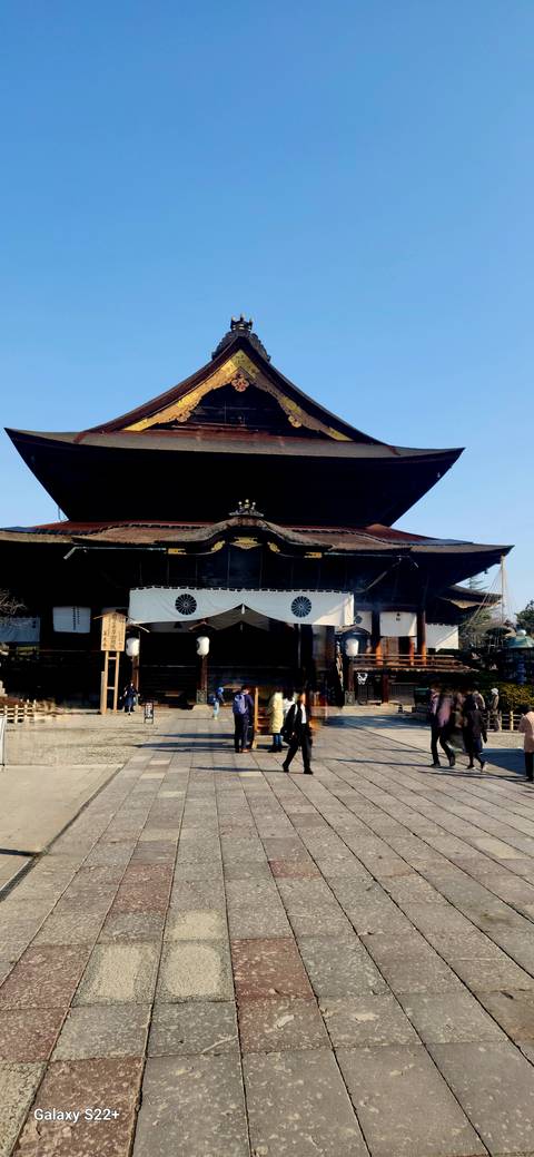 Large temple structure with people nearby.