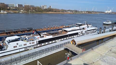       River view with docked ship.
  